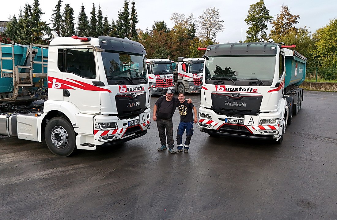 LKW-Fahrer vor Bill-Baustoffe-Fahrzeugen